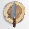 Chef's knife with a wooden handle on a wooden cutting board