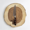 Knife with a wooden handle on a wooden cutting board